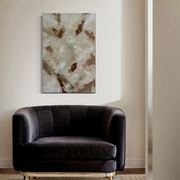 Large neutral abstract wall art displayed above a dark sofa, highlighting texture, depth, and contemporary design.